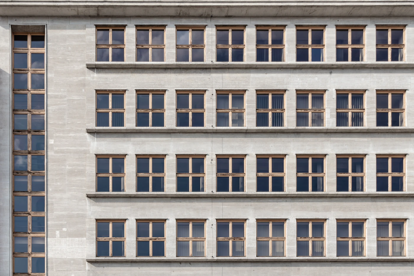 Looking straight up between tall buildings, their edges converging toward a small patch of sky