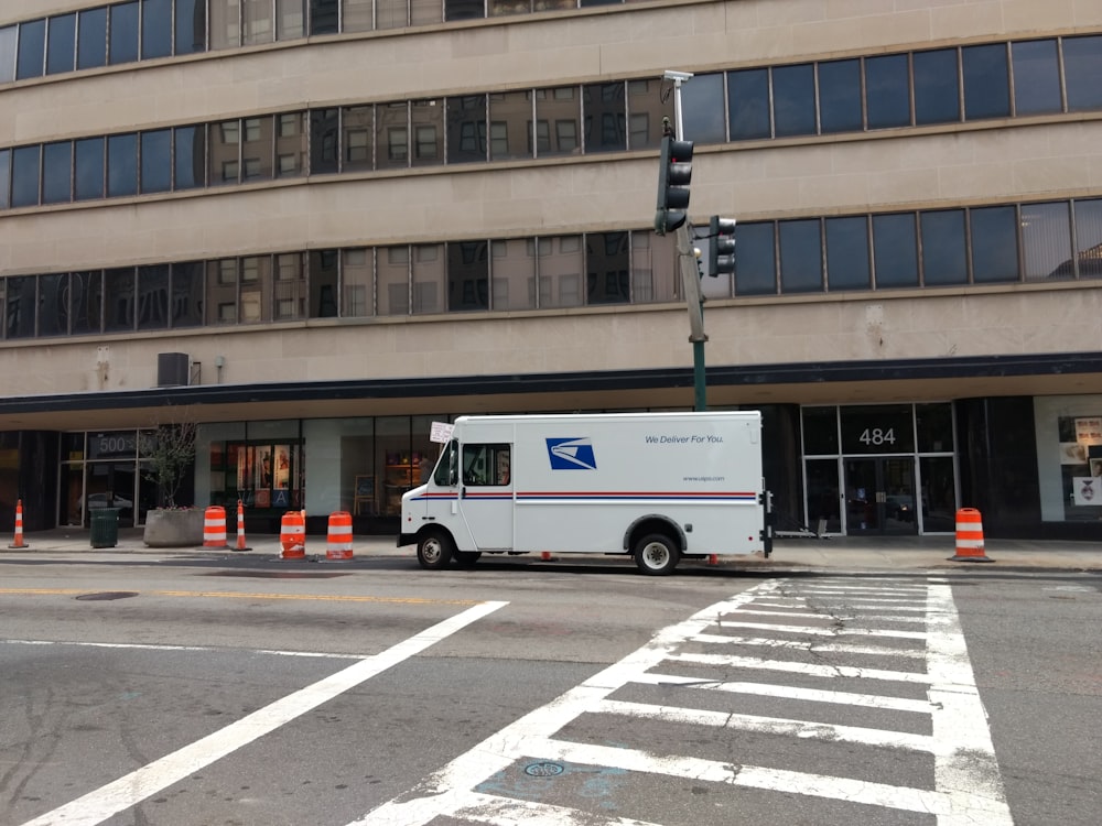 white van near concrete building