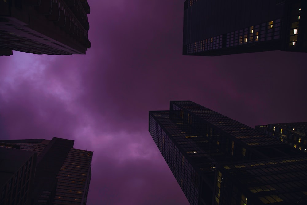 high rise buildings under cloudy sky