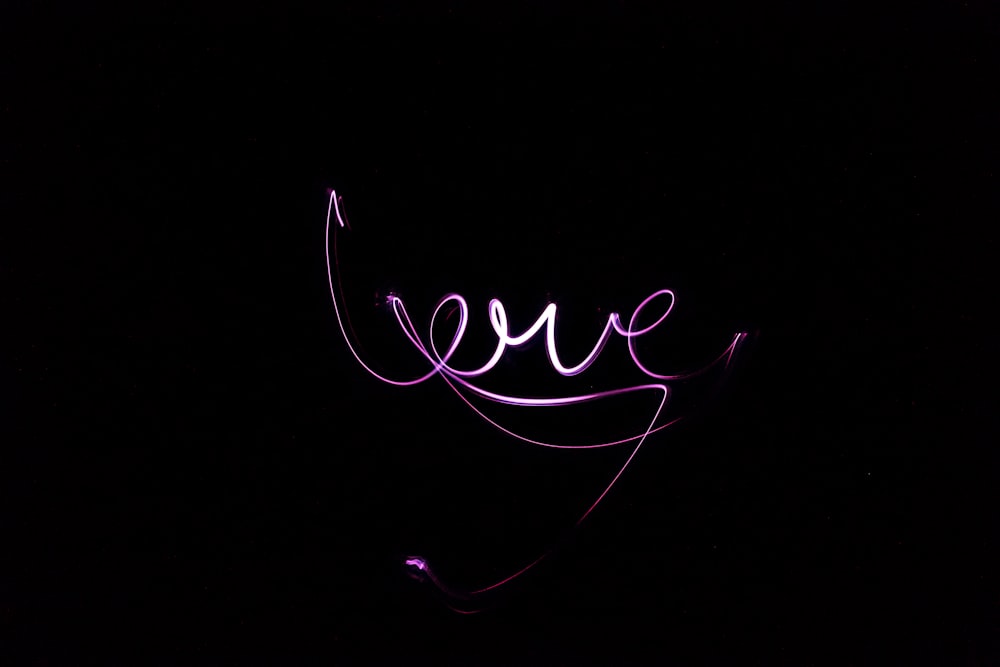 a neon sign that reads love in the dark