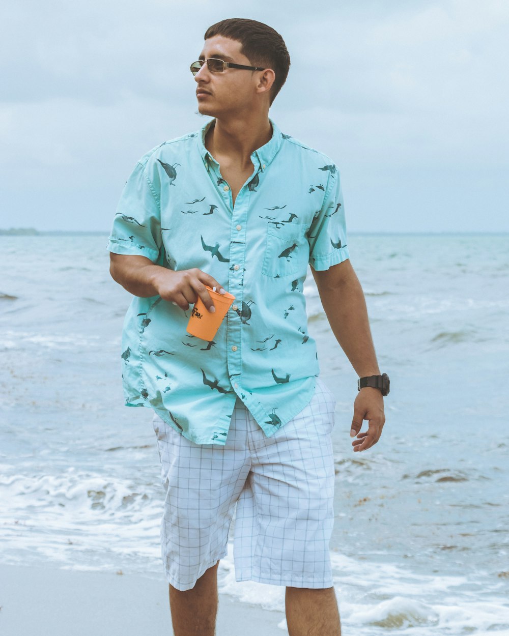 man walking beside body of water