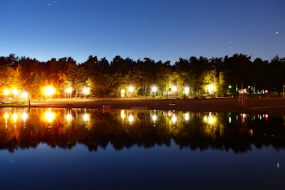 Evening sky with the first star shining brightly above the peaceful lake