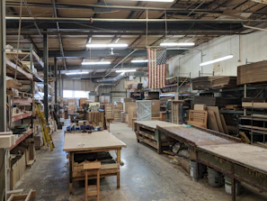 An organized workspace with birch wood accents where kitchen fixtures are carefully assembled and inspected