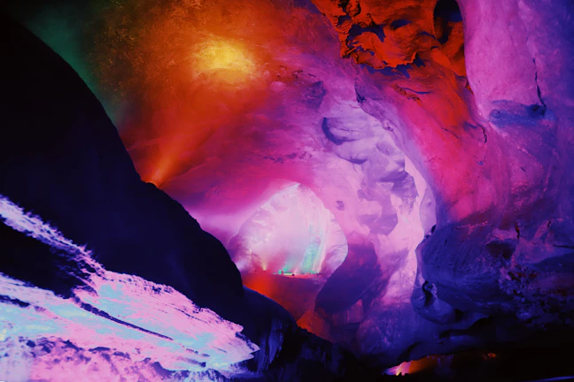 A creative Minecraft secret base hidden inside a mountain with glowing lights.