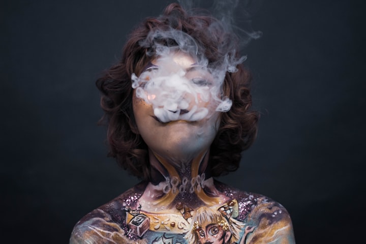 A tattooed woman releasing smoke from her mouth and nose