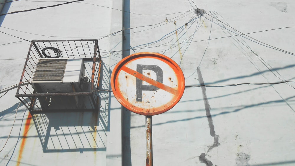 orange No parking road sign