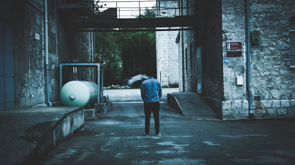 person walking on hallway near tank