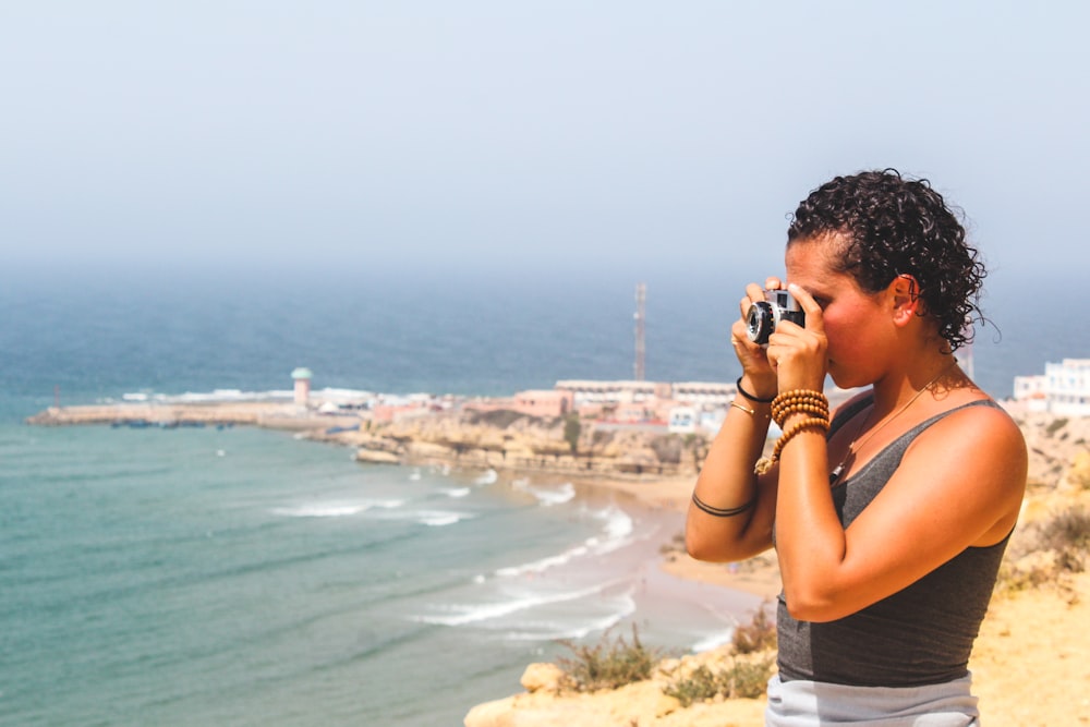 woman standing on high place taking photo