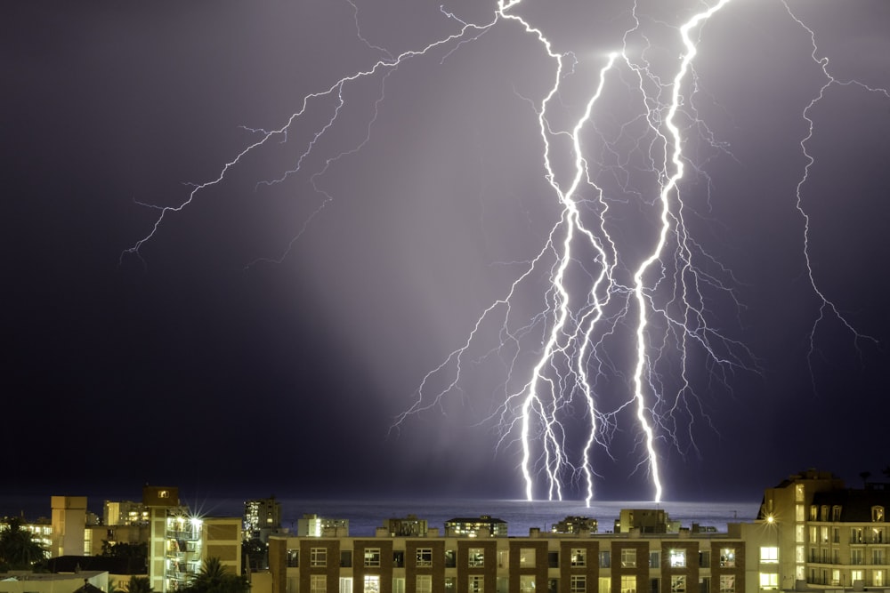 thunder on body of water near buildings