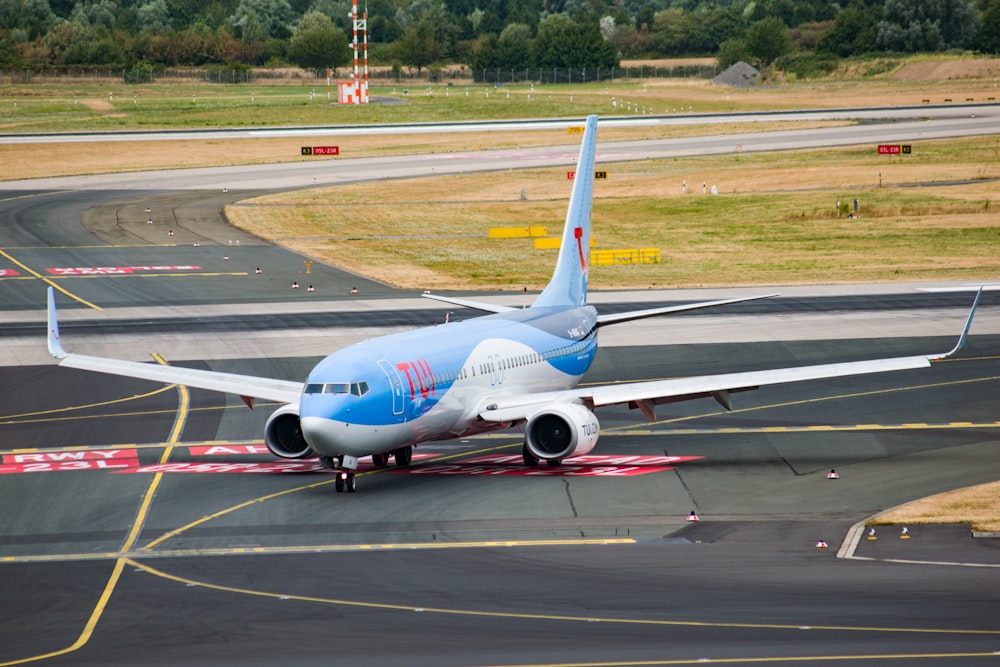 parked white and blue airplane