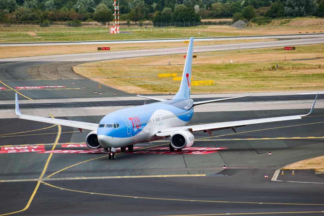 parked white and blue airplane,