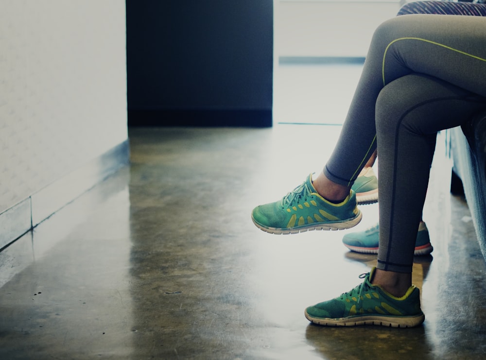 woman wearing pair of green running shoes