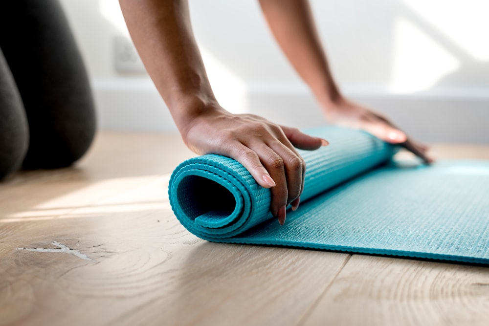 person holding teal mat