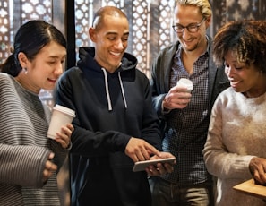 Smiling faces of members enjoying a casual coffee break after a session.