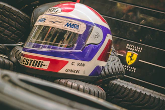 A set of high-performance tires stacked beside a racing helmet.