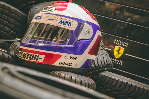 A set of high-performance tires stacked beside a racing helmet.