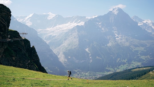 person hiking on mountain during daytime in Eiger Ultra Trail Switzerland