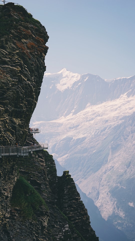 rock formation with bridge during daytime in Grindelwald Switzerland