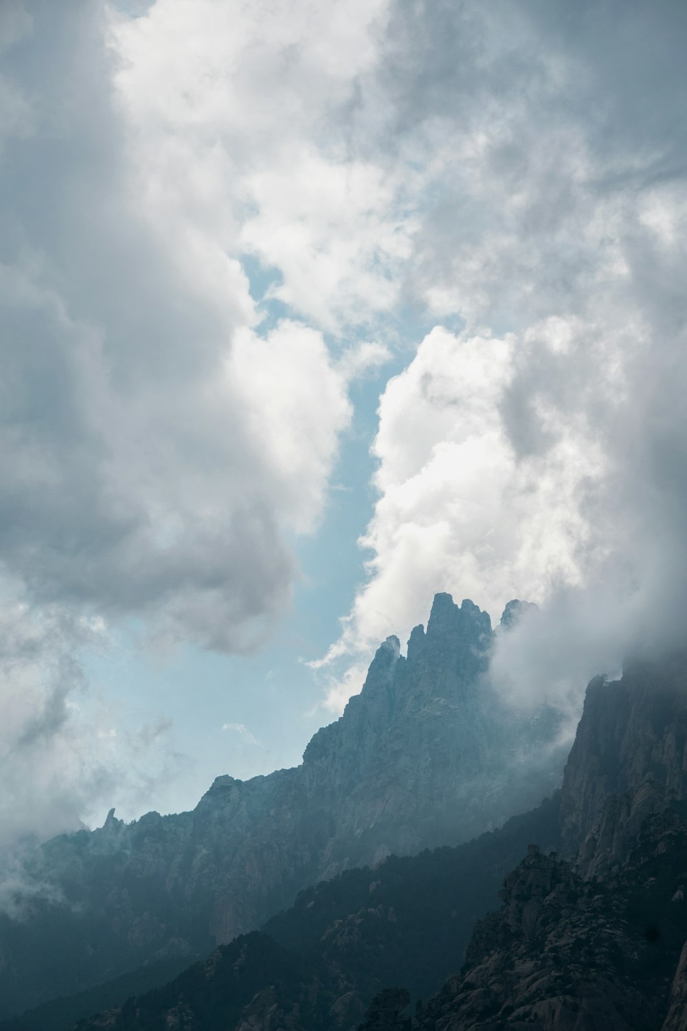 mountains under white clouds during daytime