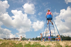 group of teens playing volleyball girl sitting on umpire's chair