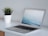 A laptop on a desk with a calming view outside the window.
