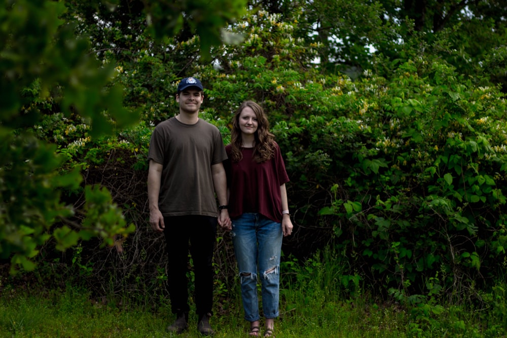 man and woman standing on green grass