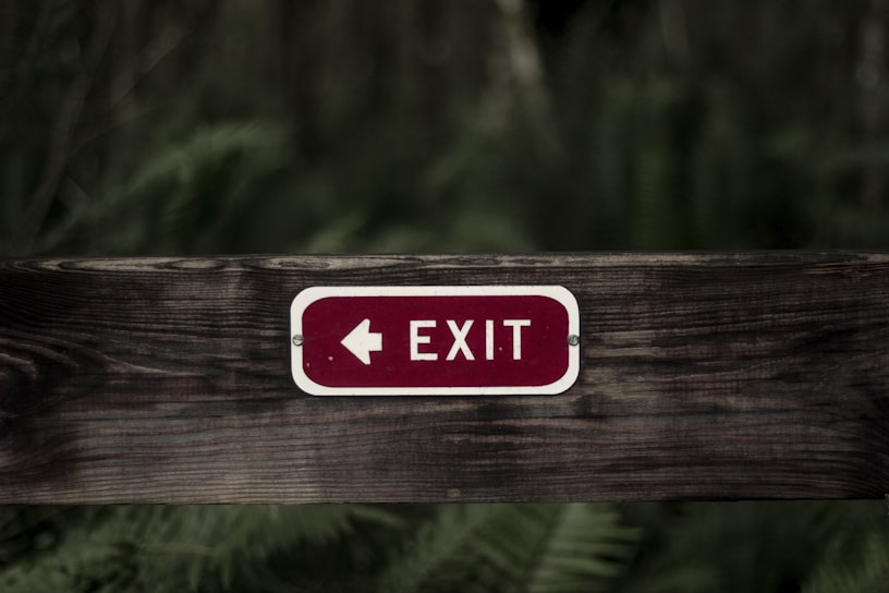exit signage on wooden plank