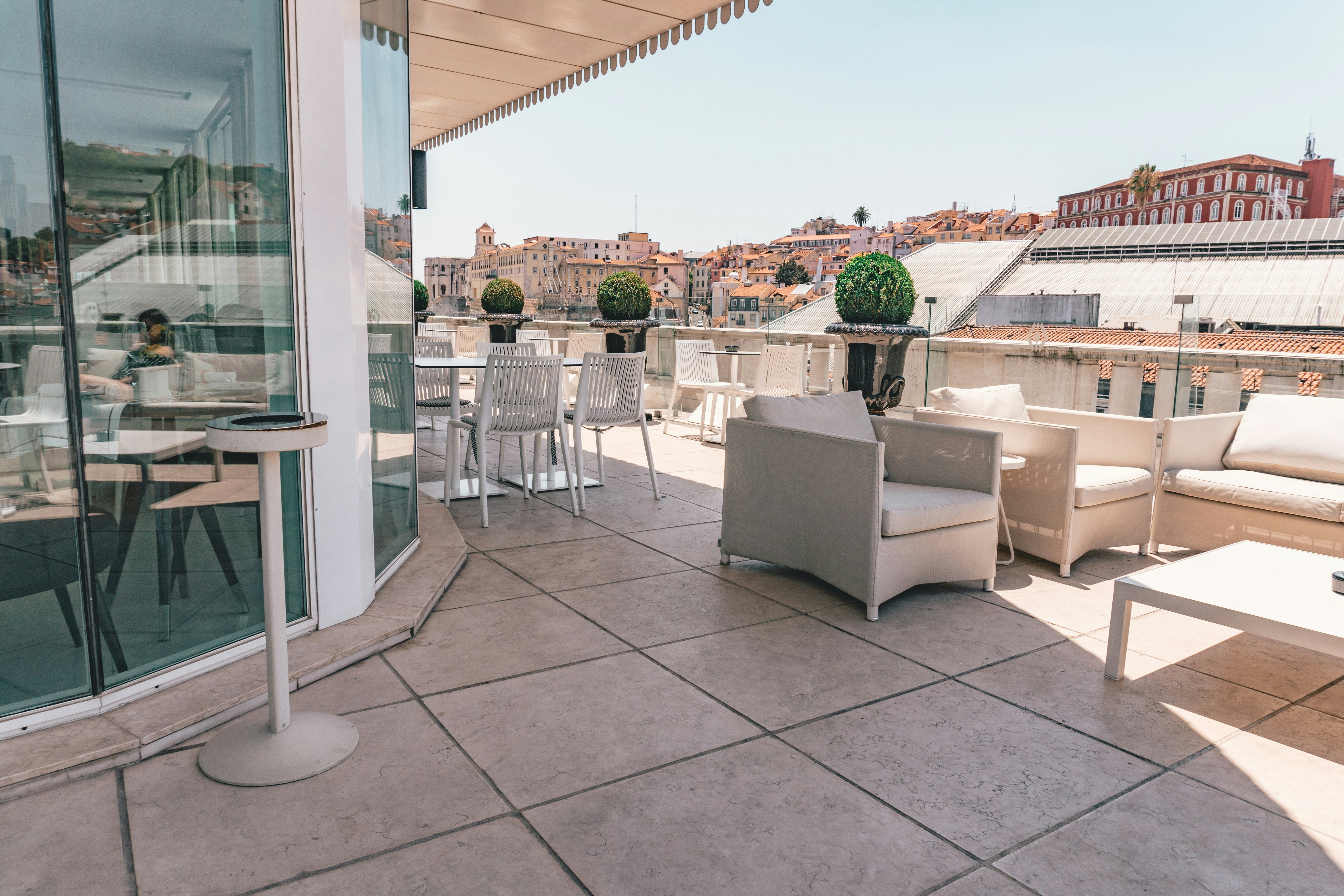 white armchairs in front of store, Lisbon Rooftop Bar