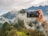 person holding smartphone taking picture of green mountain