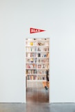 white wooden shelf with assorted books
