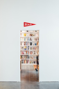 white wooden shelf with assorted books