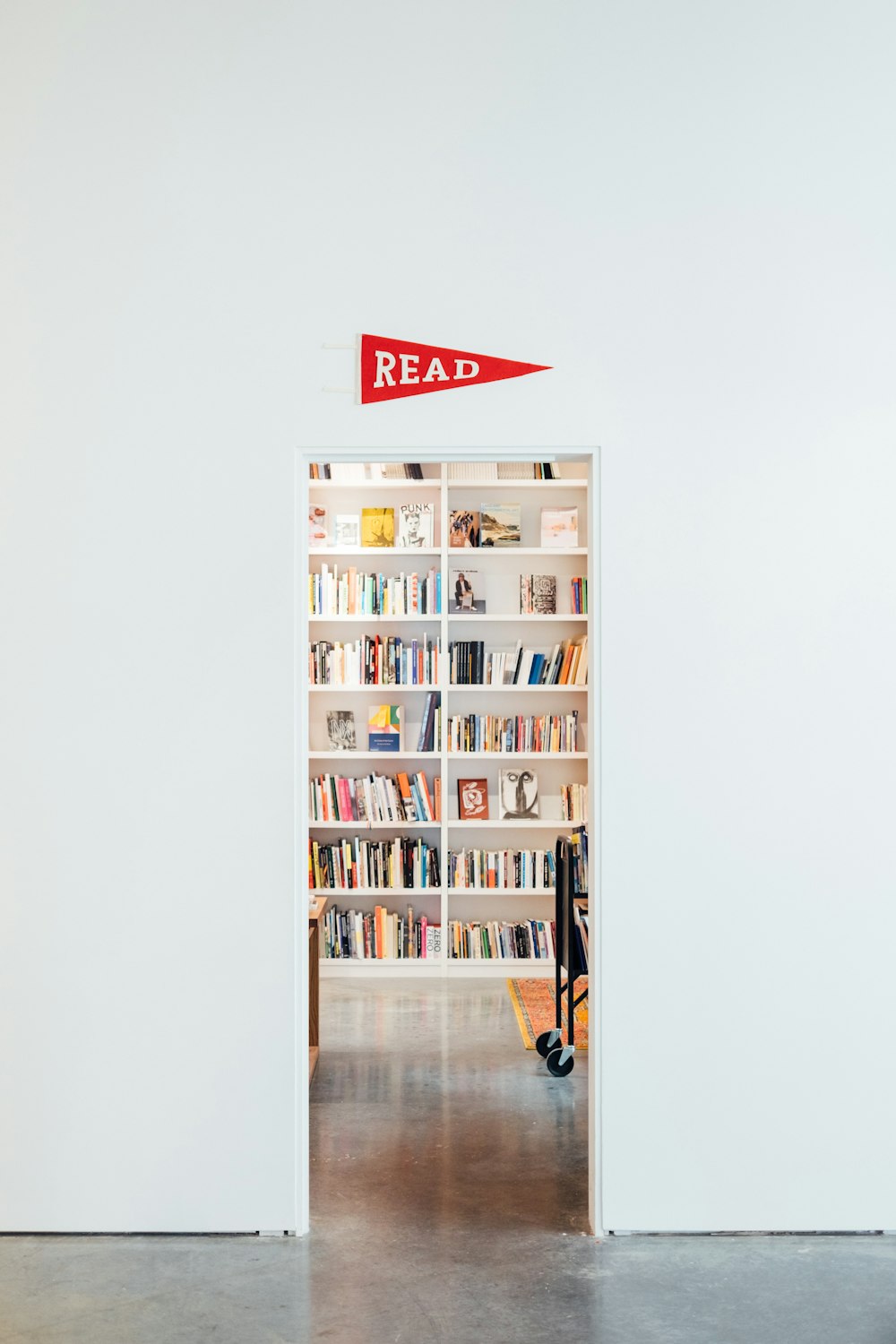 white wooden shelf with assorted books