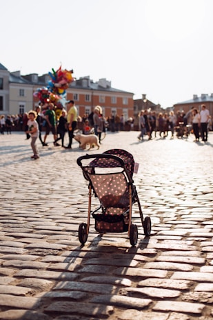 Close-up of the dootm™ stroller's smooth wheels on a city sidewalk.
