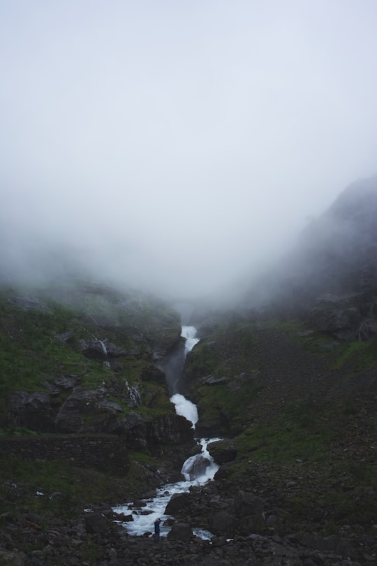 river in mountain with white fog in Trollstigen Norway