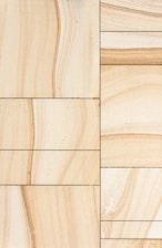 Sophisticated natural stone tiles arranged in a minimalistic setting with fendi-toned backgrounds.