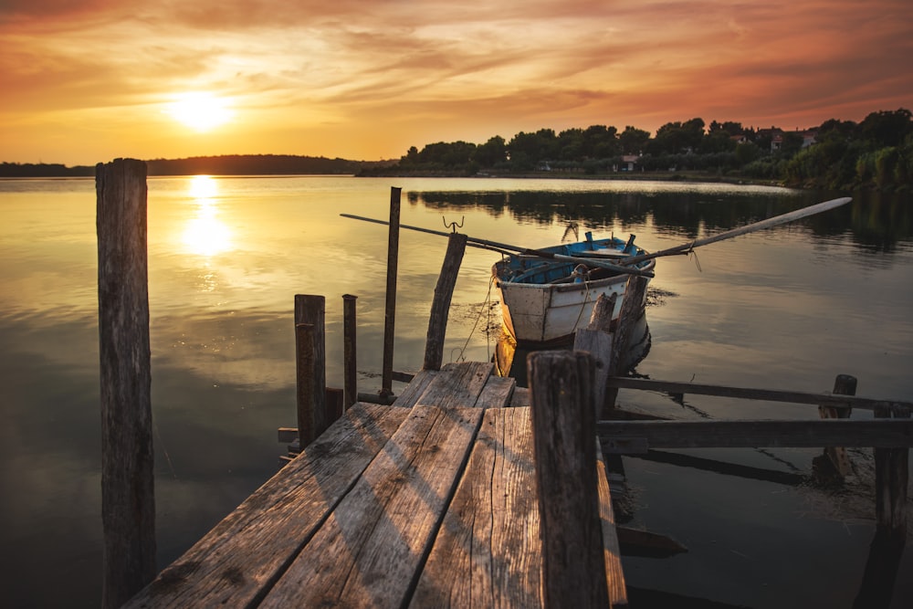 white wooden boat near wooden dock