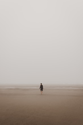 man standing on brown sand