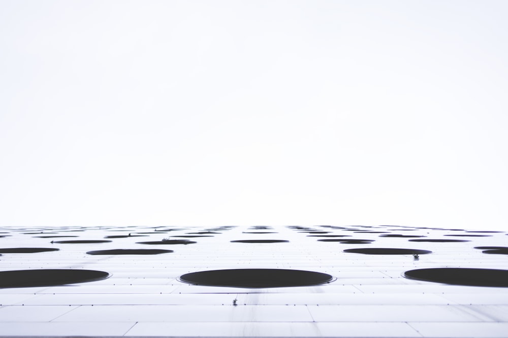 a tall building with lots of black circles on it