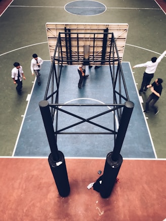 people standing under basketball hoop