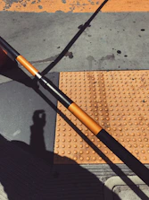 Close-up of yellow tactile flooring installed in a busy urban sidewalk.
