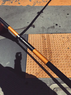 Close-up of yellow tactile flooring installed in a busy urban sidewalk.