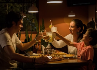 three people having a toast on table