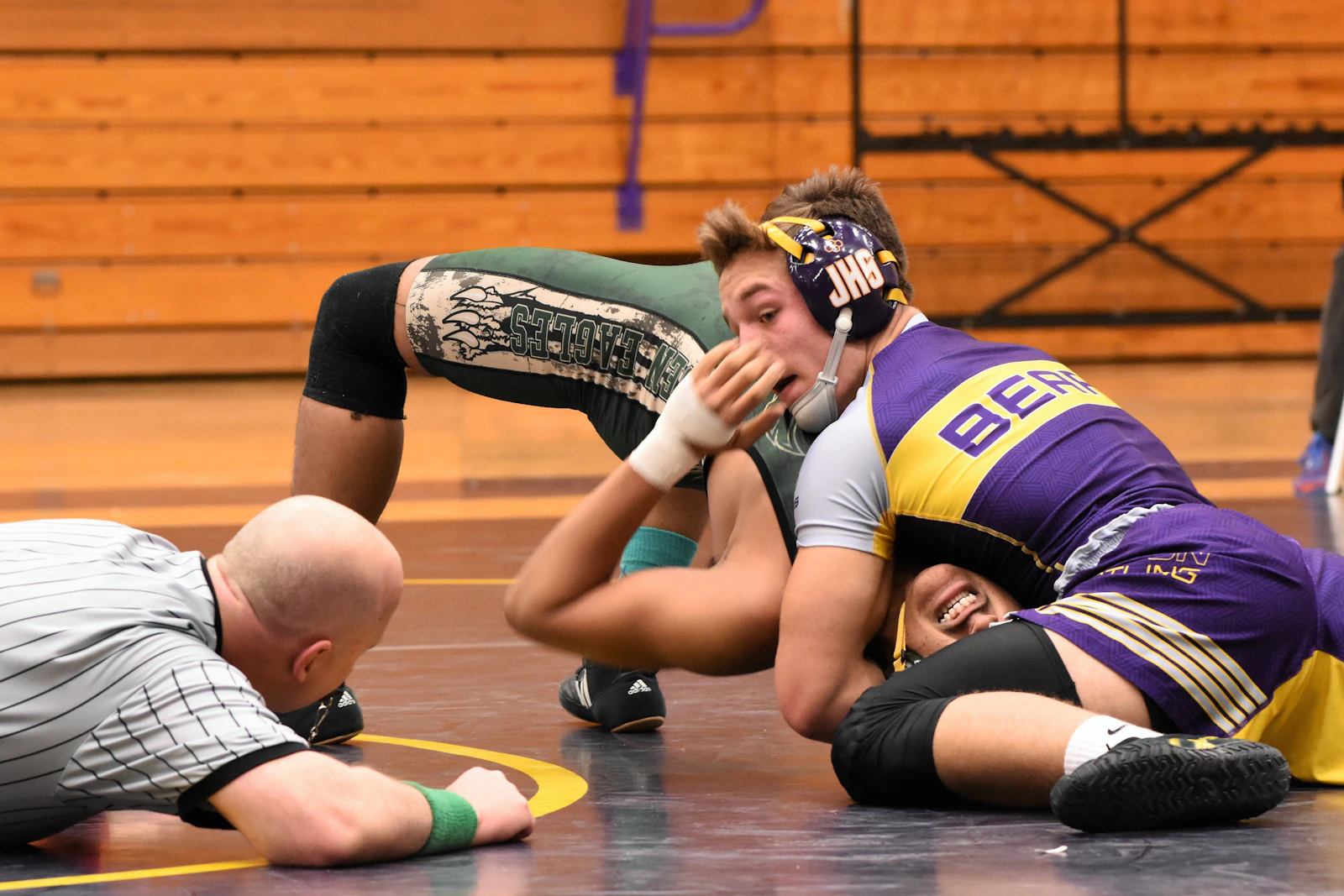 A wrestler working for a pin on the mat