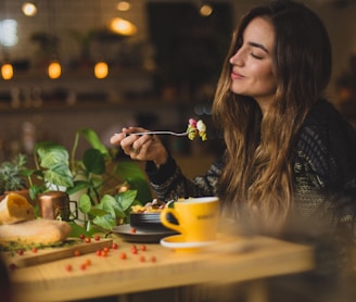 woman holding fork in front table