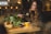 A happy customer enjoying a freshly prepared meal in a cozy kitchen setting.