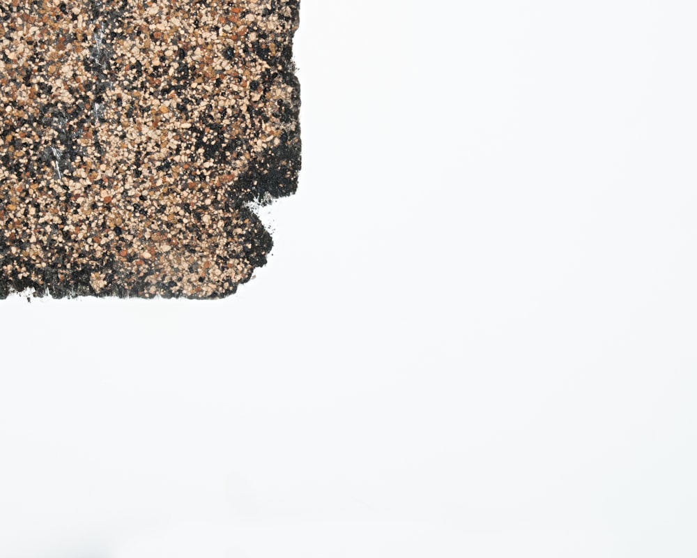 a close up of a piece of food on a white surface