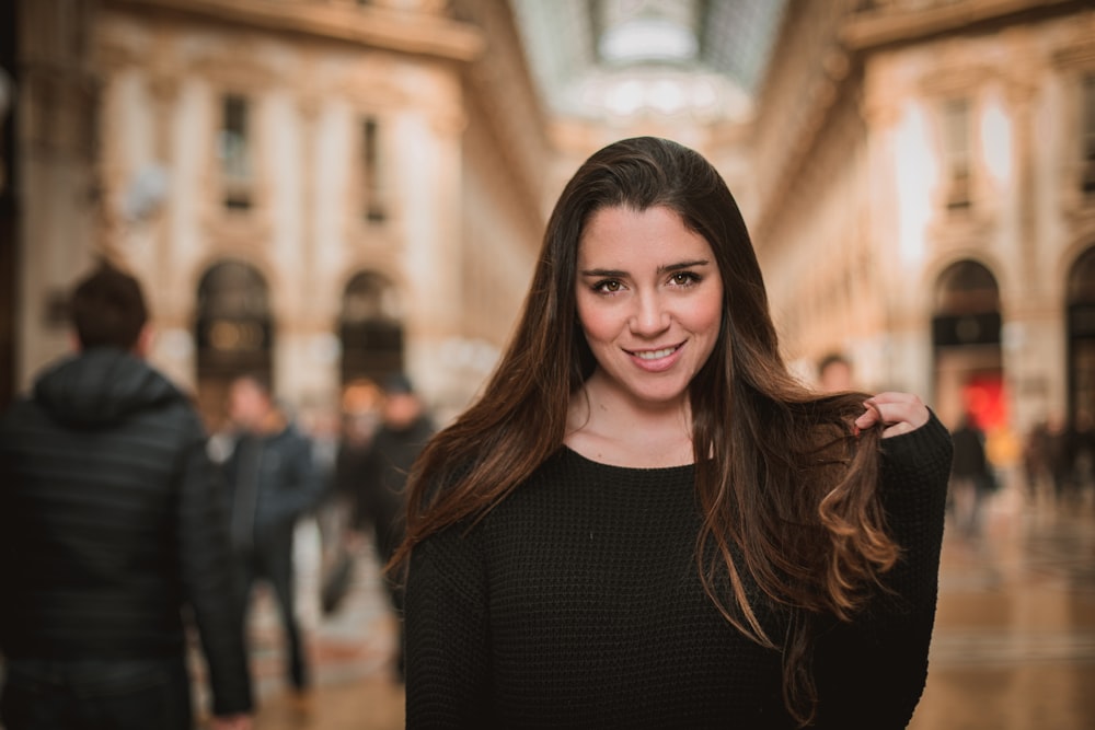 smiling woman in black long-sleeved top