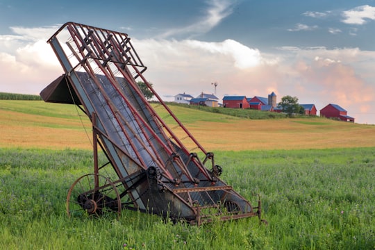 grey and red metal harvester machine on green field in Kidron United States