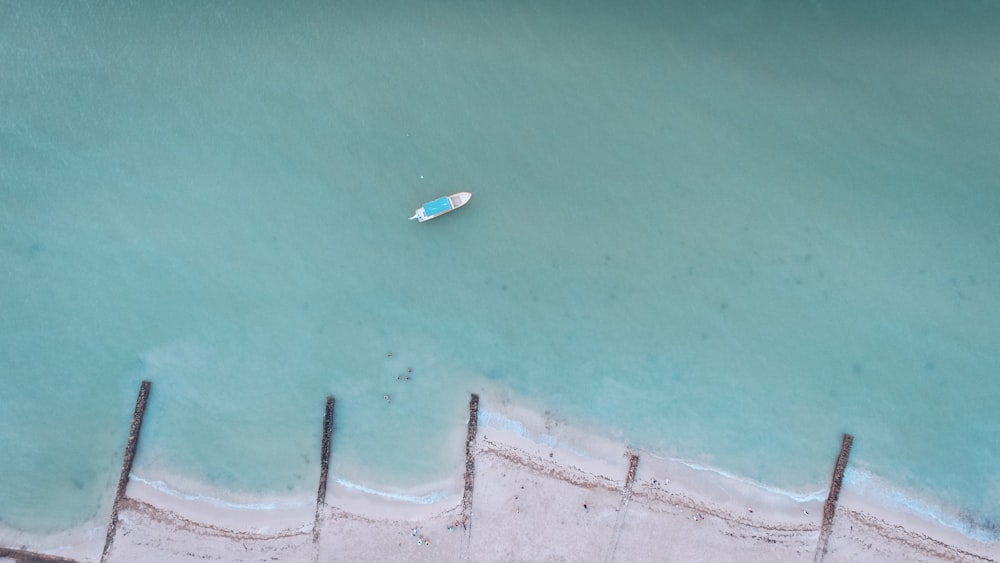 white boat on water at daytime