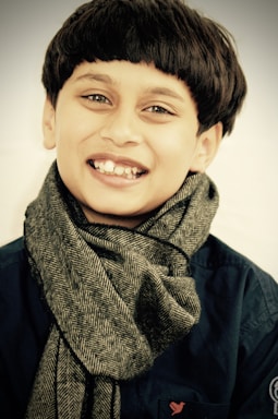 A warm portrait of a Wayuu child smiling in the Guajira desert.